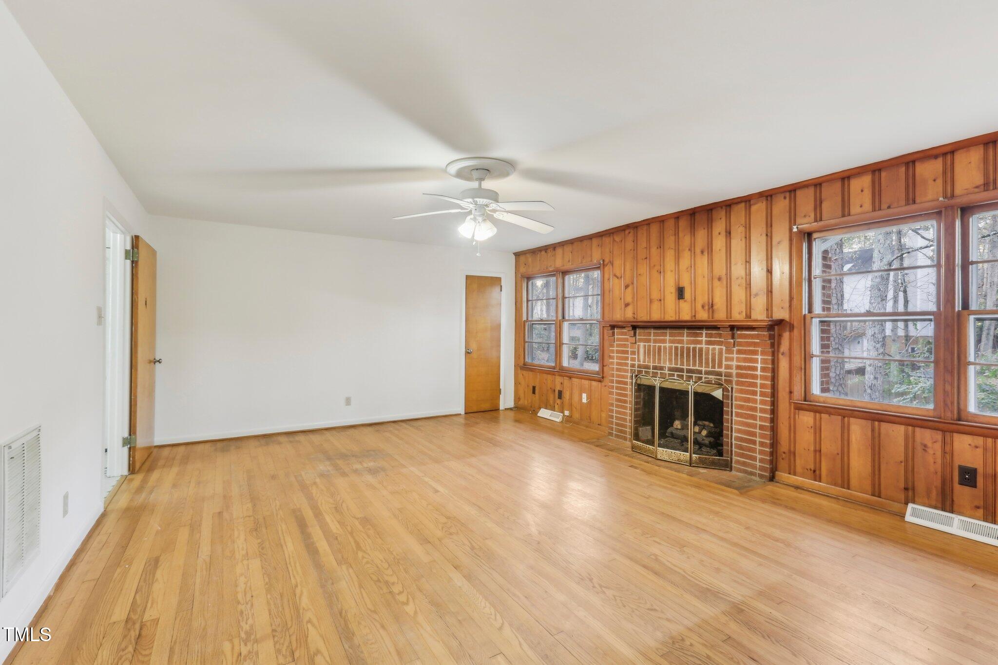 209 High House Road Cary, NC 27513 - Photo 6 of 40 a view of empty room with fireplace and wooden floor