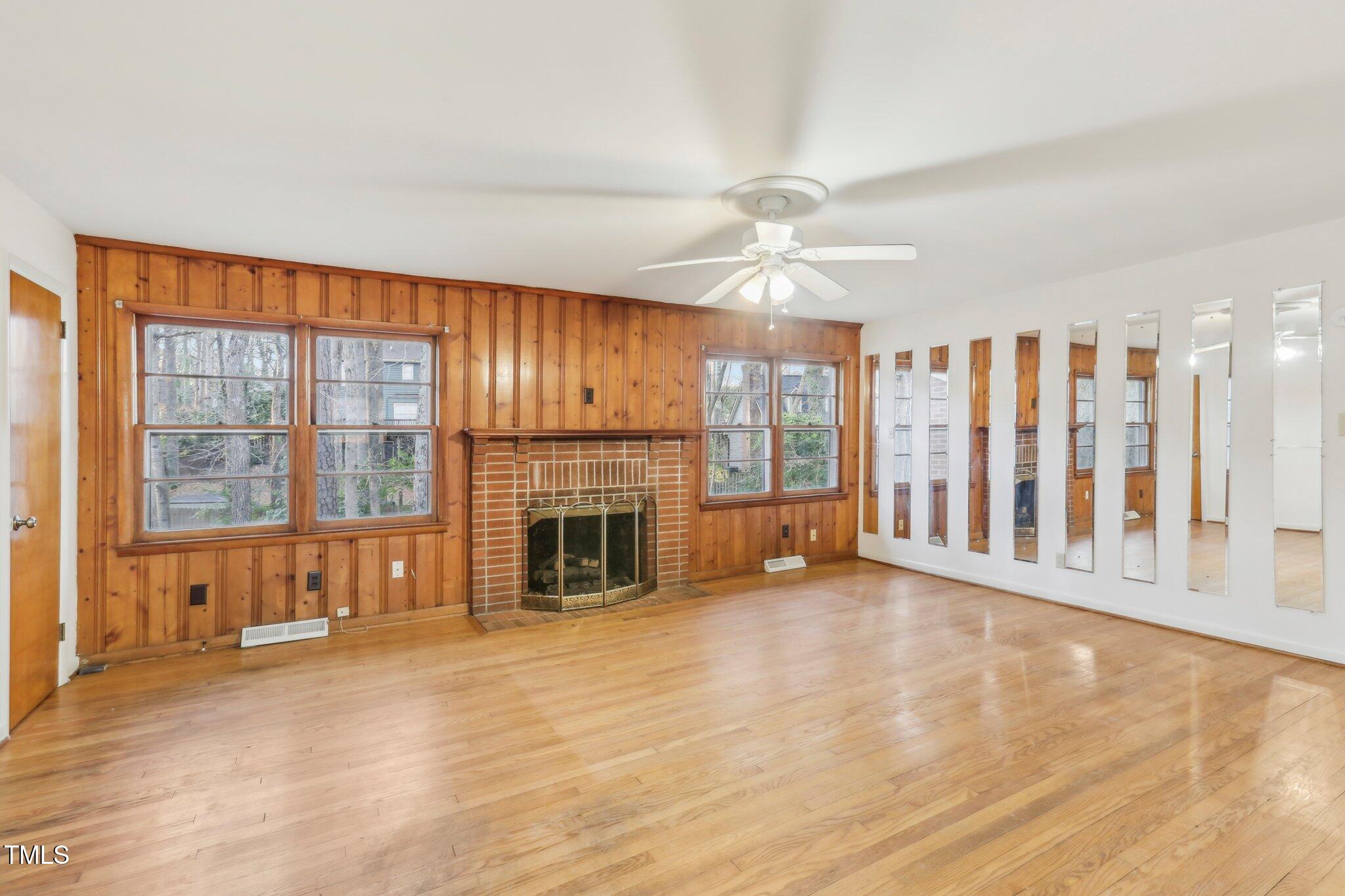 209 High House Road Cary, NC 27513 - Photo 8 of 40 a view of an empty room with a fireplace and a window