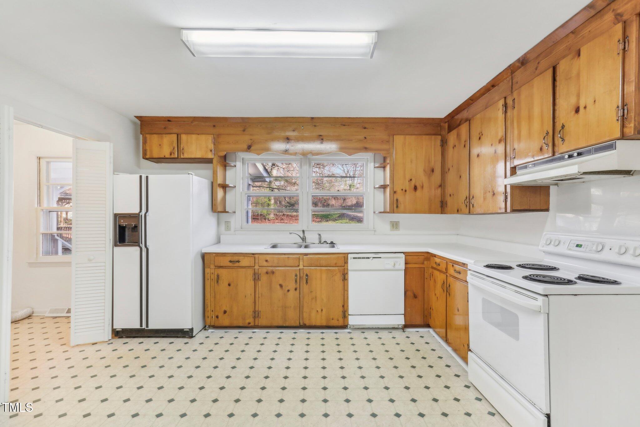 209 High House Road Cary, NC 27513 - Photo 9 of 40 a kitchen with stainless steel appliances granite countertop a stove a sink and a refrigerator