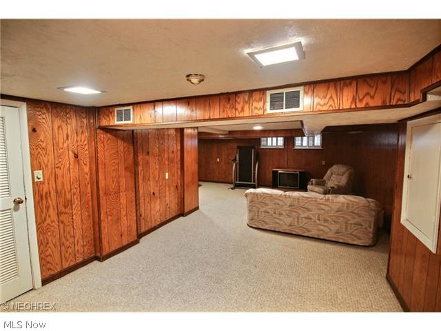 16015 Fernway Road Cleveland, OH 44120 - Photo 14 of 15 Lower level paneled media/great room with berber carpet.