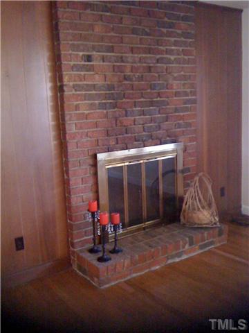 3501 Mercury Circle Raleigh, NC 27604 - Photo 6 of 11 The living rooms features hardwood floors and a cozy fireplace.