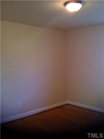 3501 Mercury Circle Raleigh, NC 27604 - Photo 10 of 11 Bedroom two with hardwood floors and updated lighting.