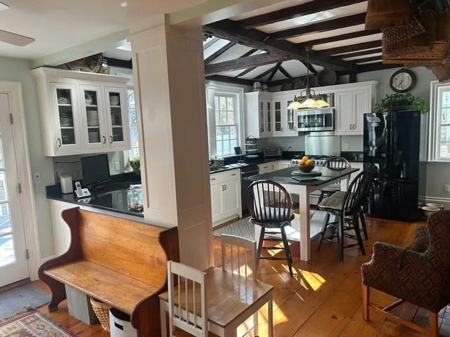 a dining room with furniture a rug and wooden floor