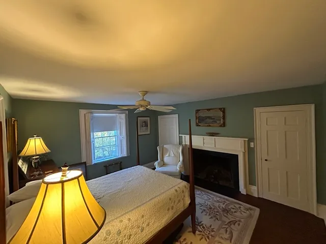 a bedroom with a bed and a fireplace