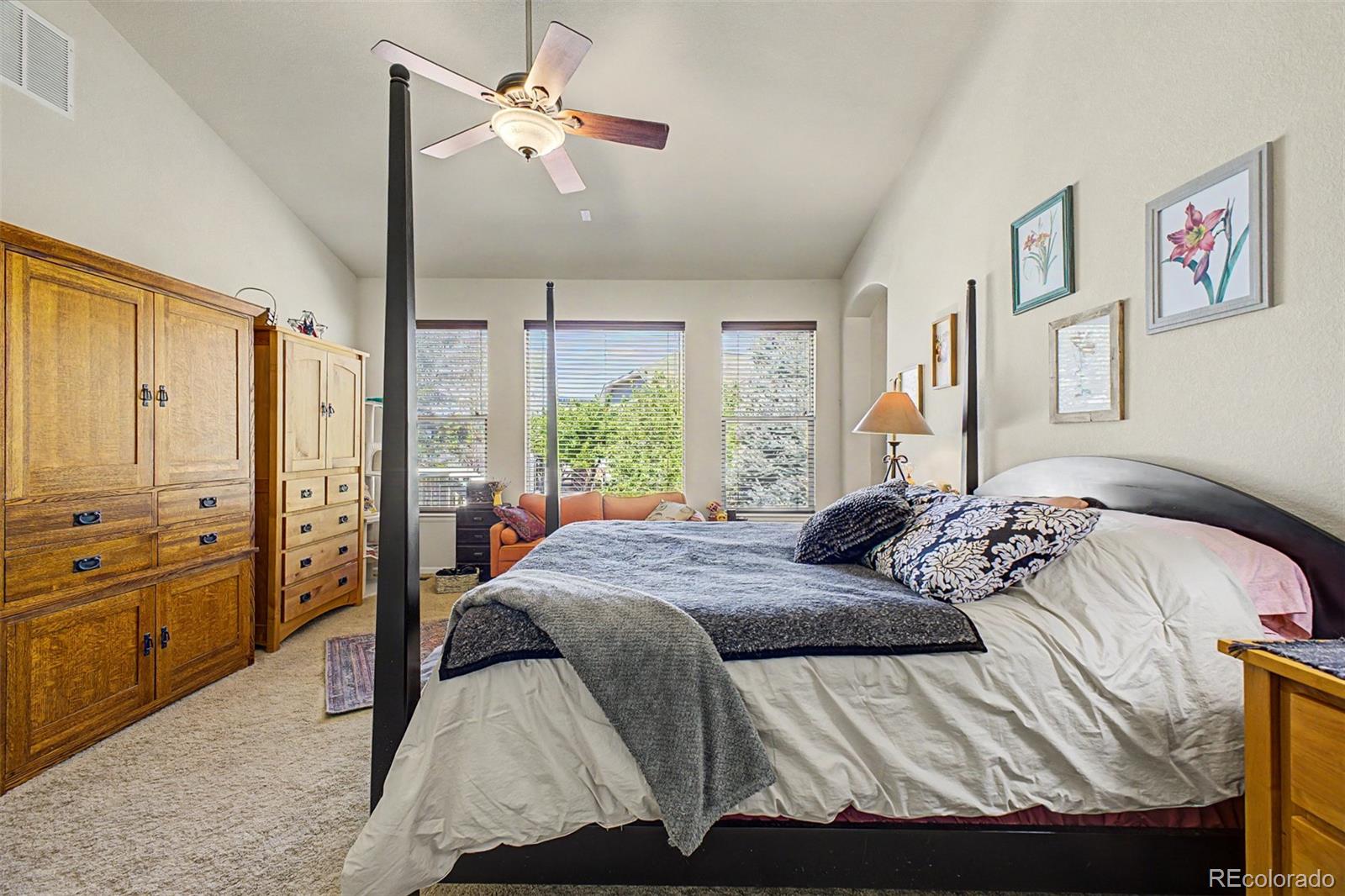 3343 Fantasy Place Castle Rock, CO 80109 - Photo 14 of 50 a bedroom with a large bed and a chandelier