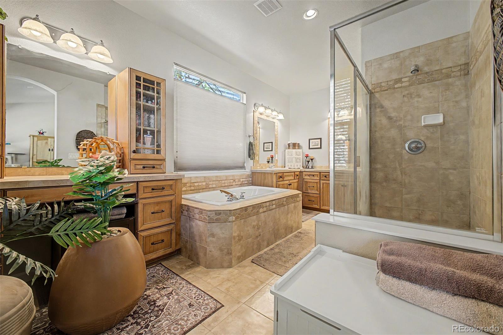 3343 Fantasy Place Castle Rock, CO 80109 - Photo 16 of 50 a spacious bathroom with a granite countertop sink a toilet and shower