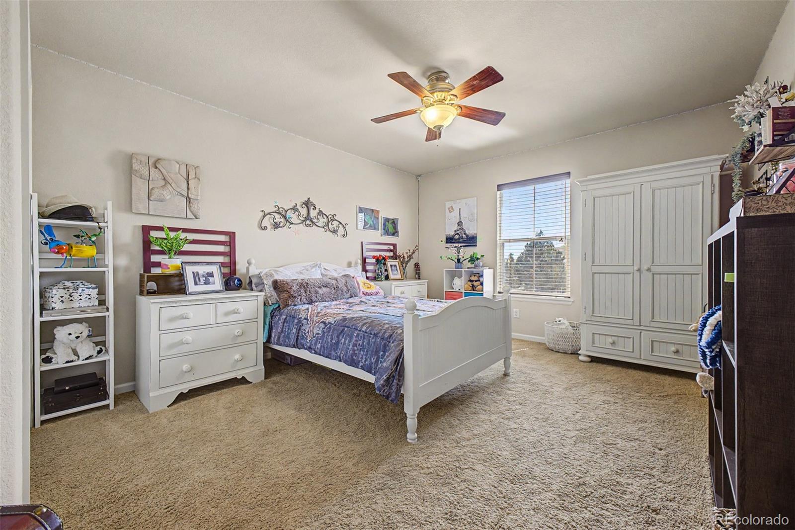 3343 Fantasy Place Castle Rock, CO 80109 - Photo 18 of 50 a bedroom with a bed and a chandelier