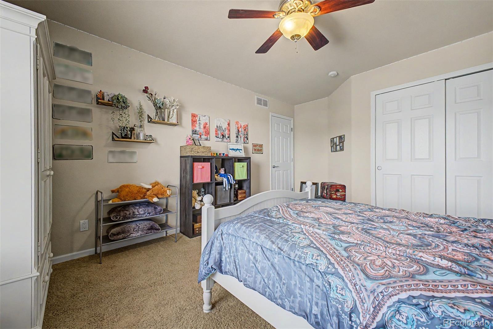 3343 Fantasy Place Castle Rock, CO 80109 - Photo 19 of 50 a bedroom with a bed and a chandelier