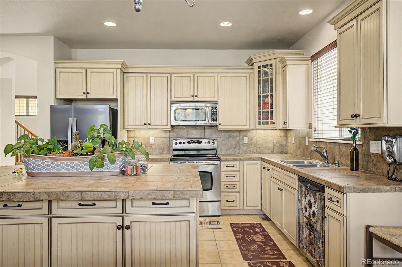 3343 Fantasy Place Castle Rock, CO 80109 - Photo 2 of 50 a kitchen with a white cabinets and appliances