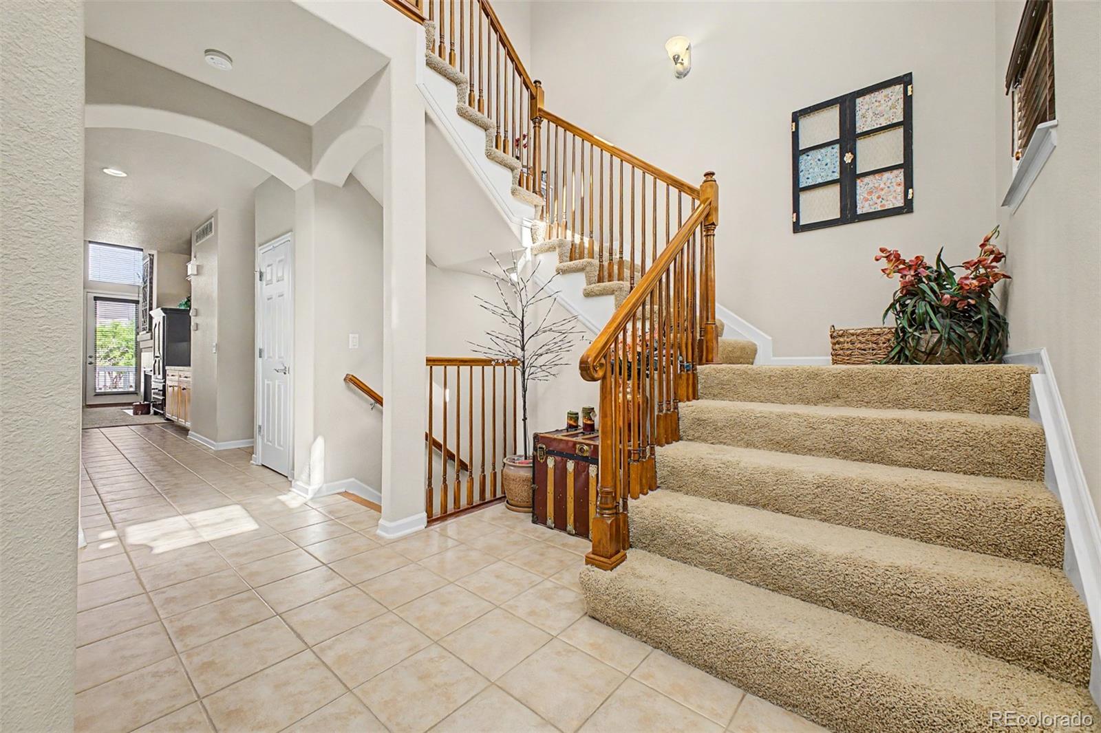3343 Fantasy Place Castle Rock, CO 80109 - Photo 3 of 50 a view of staircase with lots of frames and couches
