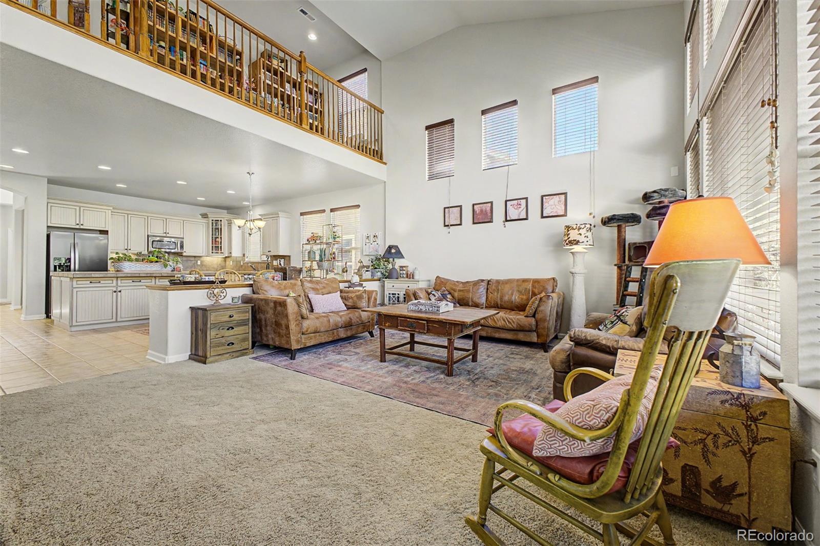 3343 Fantasy Place Castle Rock, CO 80109 - Photo 6 of 50 a living room with furniture and a kitchen