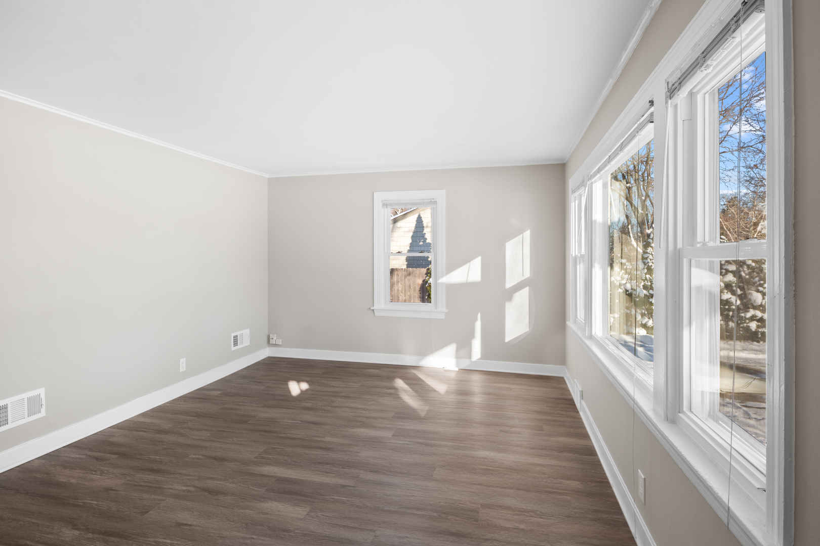 5604 South Madison Avenue Countryside, IL 60525 - Photo 2 of 38 a view of an empty room with wooden floor and a window