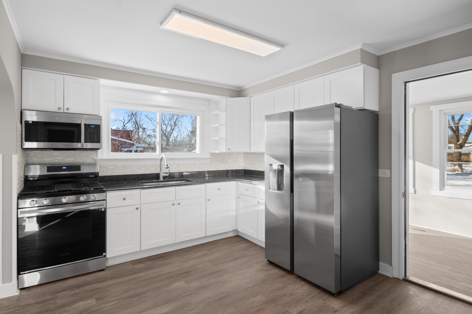 5604 South Madison Avenue Countryside, IL 60525 - Photo 10 of 38 a kitchen with granite countertop a refrigerator stove and microwave
