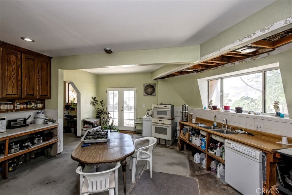 45985 Cottonwood Road Newberry Springs, CA 92365 - Photo 14 of 67 a kitchen with sink a stove and chairs