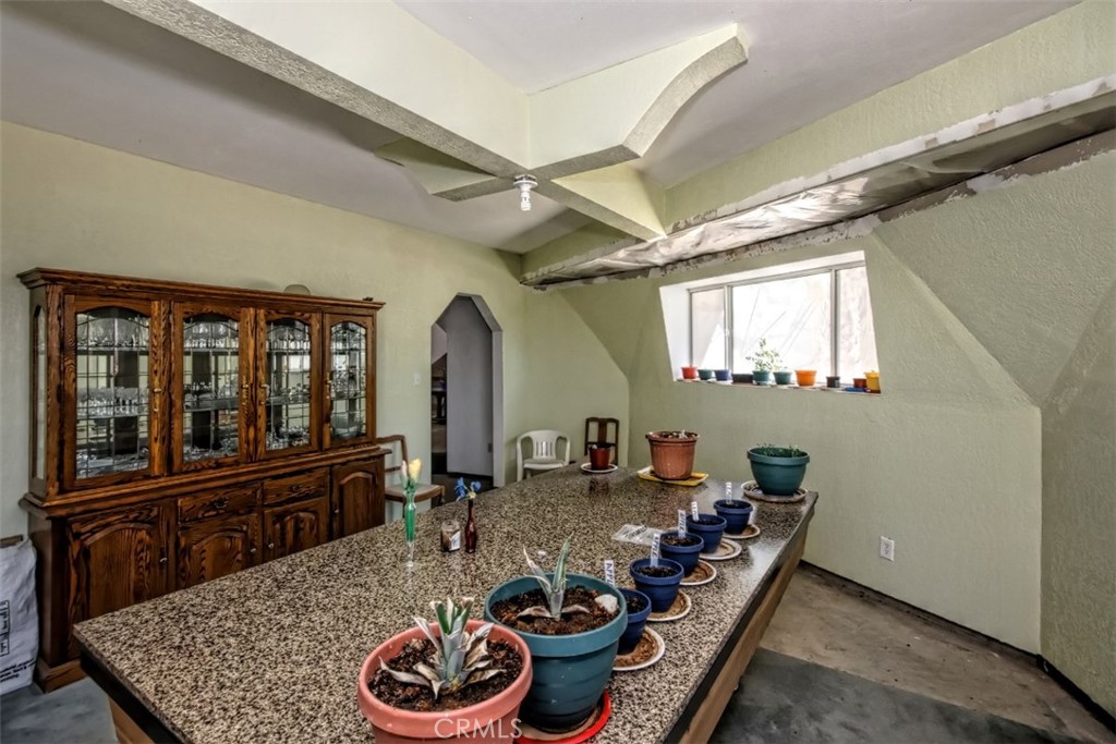 45985 Cottonwood Road Newberry Springs, CA 92365 - Photo 17 of 67 a room with lots of chairs and a potted plant