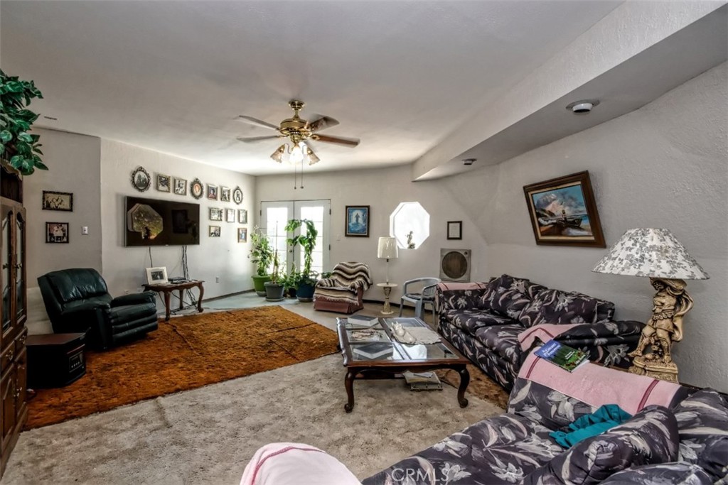45985 Cottonwood Road Newberry Springs, CA 92365 - Photo 21 of 67 a living room with patio furniture and a flat screen tv