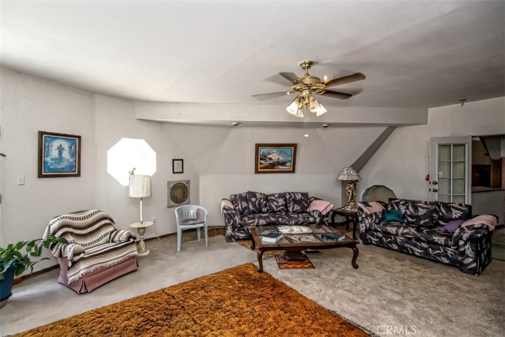 45985 Cottonwood Road Newberry Springs, CA 92365 - Photo 22 of 67 a living room with furniture a rug and a chandelier