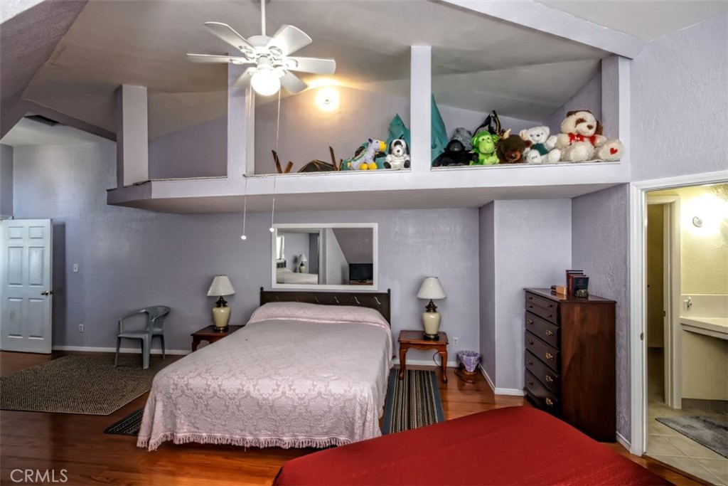 45985 Cottonwood Road Newberry Springs, CA 92365 - Photo 36 of 67 a bedroom with a bed and a chandelier