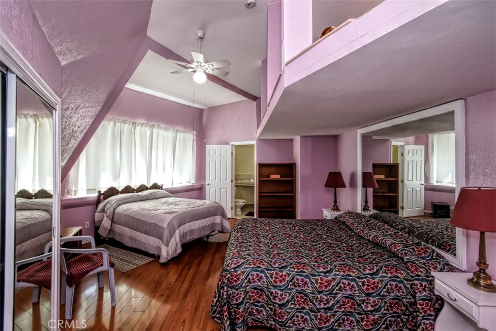 45985 Cottonwood Road Newberry Springs, CA 92365 - Photo 40 of 67 a bedroom with bed and large windows