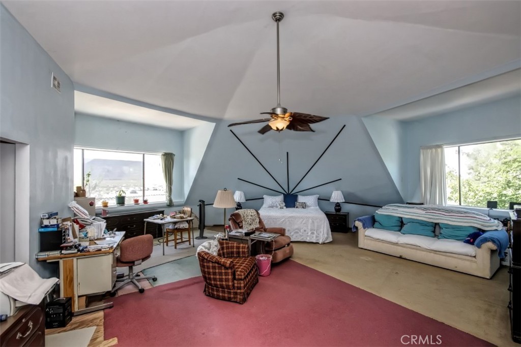 45985 Cottonwood Road Newberry Springs, CA 92365 - Photo 44 of 67 a living room with lots of furniture and a chandelier