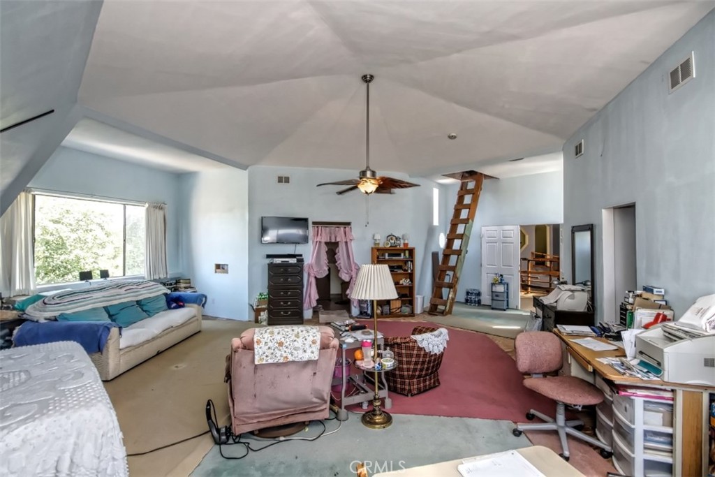 45985 Cottonwood Road Newberry Springs, CA 92365 - Photo 45 of 67 a living room filled with furniture and a chandelier