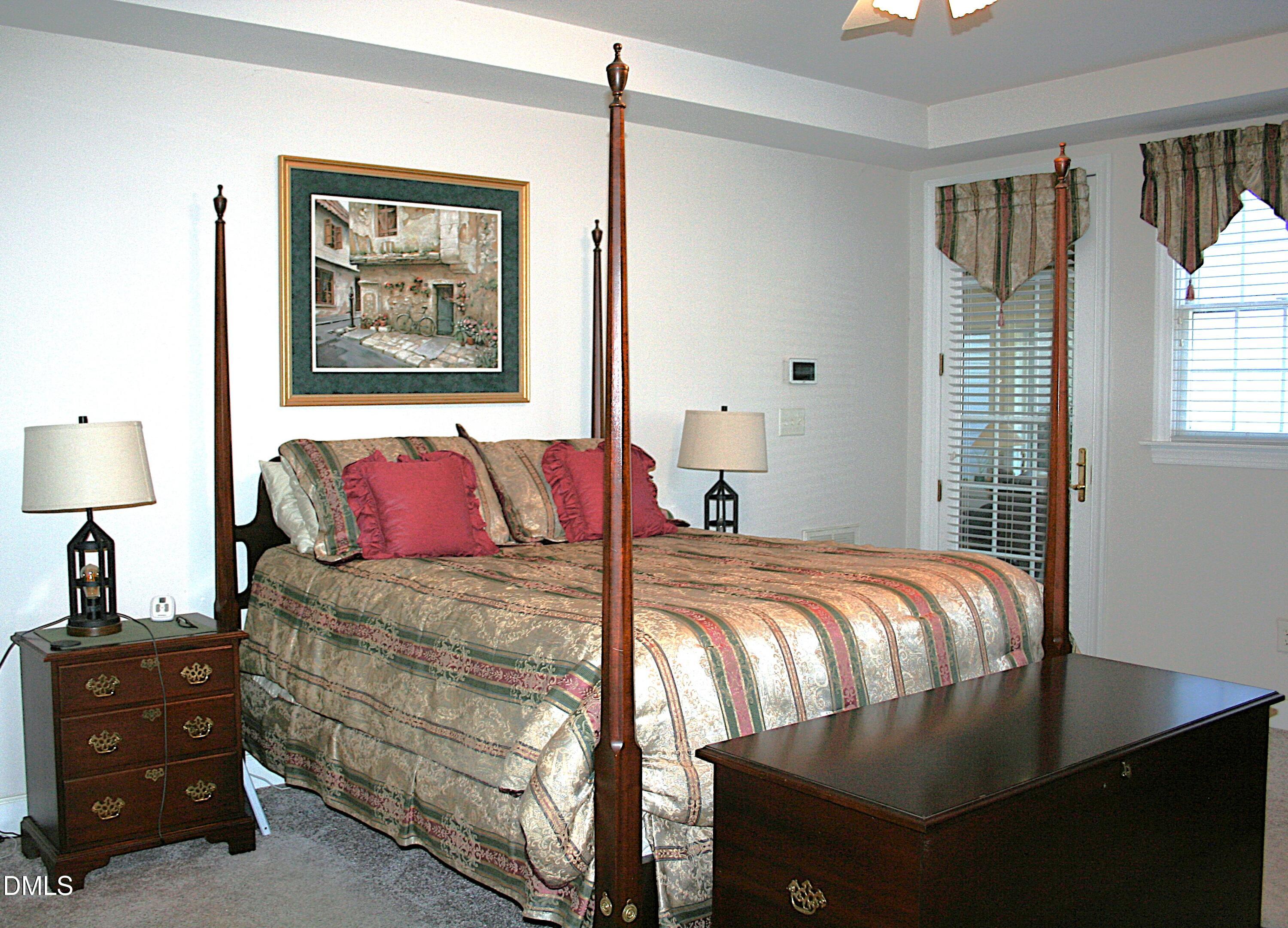 220 Jordan Narron Road Selma, NC 27576 - Photo 35 of 87 a bedroom with a bed and a lamp on dresser