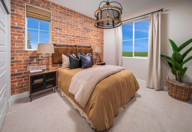 a bed sitting in a bedroom next to a window