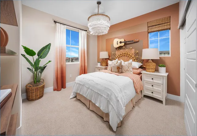 a bedroom with bed and a potted plant