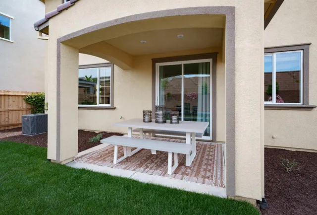 a view of a house with a yard and sitting area