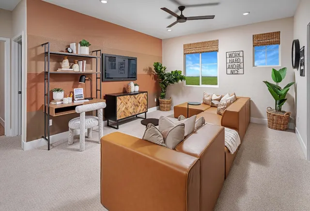 a living room with furniture and a bookshelf
