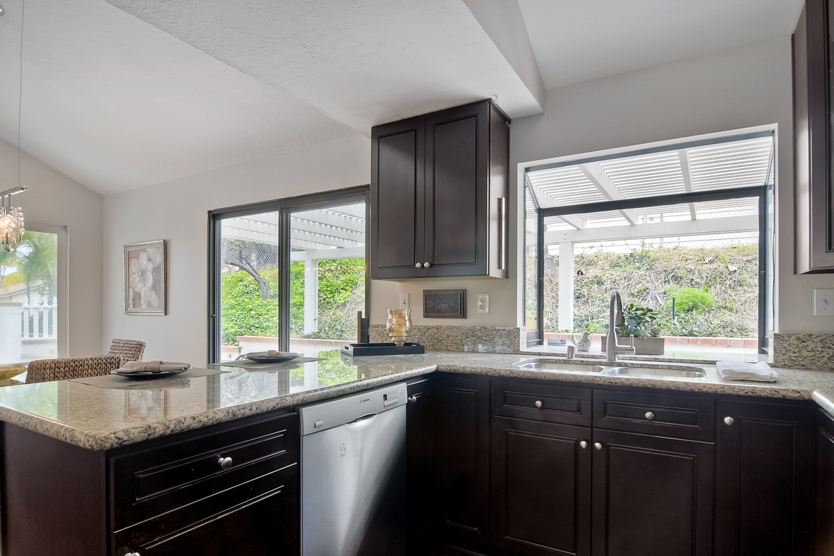 1845 Lodgepole Road San Marcos, CA 92078 - Photo 6 of 25 Granite counter tops in kitchen with view to patio.