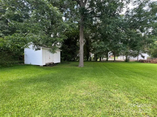 a view of a backyard with large trees