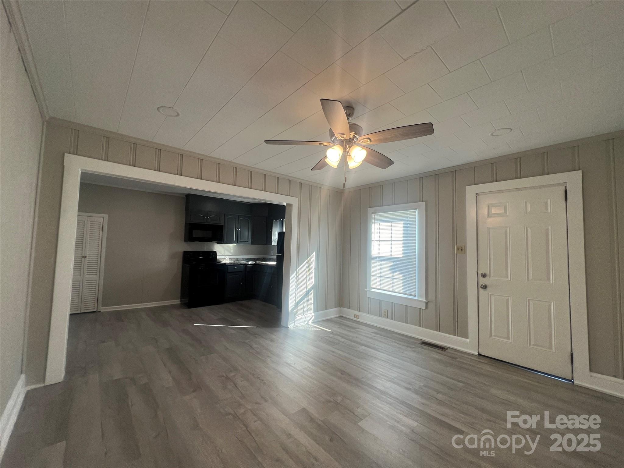 111 East Maryland Avenue Bessemer City, NC 28016 - Photo 3 of 11 a view of a kitchen with a sink stove cabinets and empty room