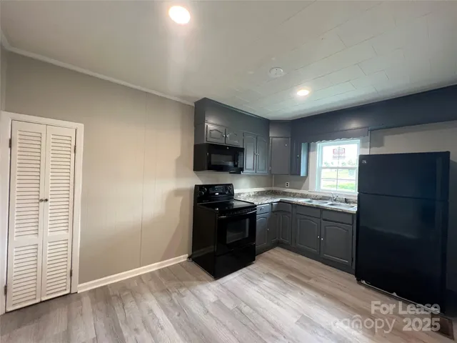 a kitchen with granite countertop stainless steel appliances and wooden cabinets