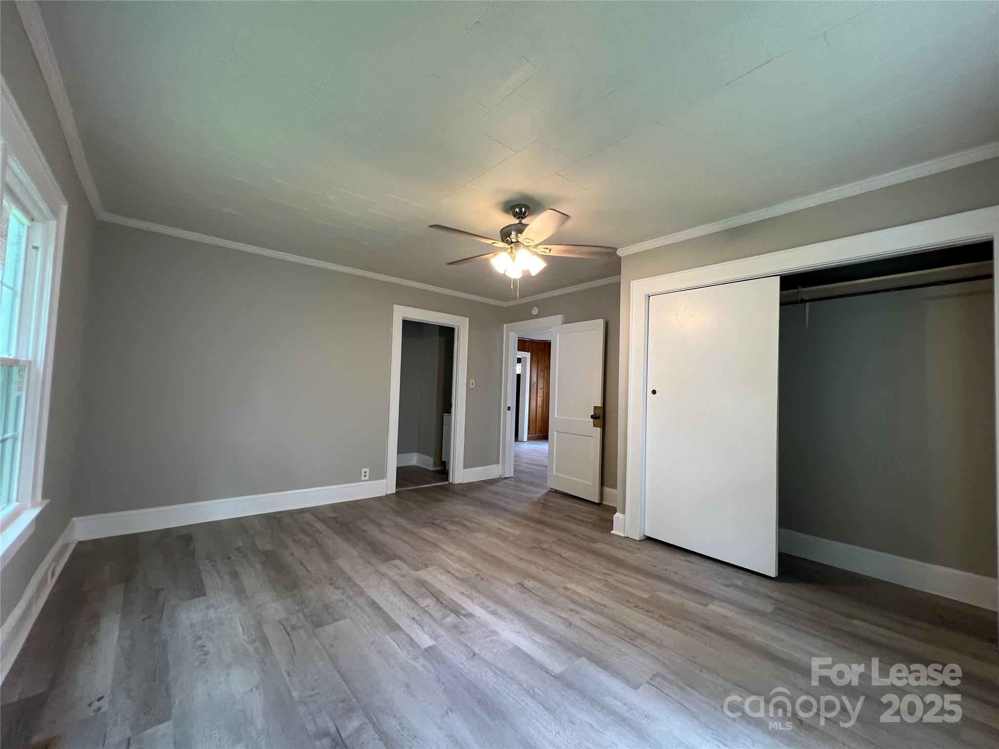 111 East Maryland Avenue Bessemer City, NC 28016 - Photo 5 of 11 wooden floor in an empty room with a window