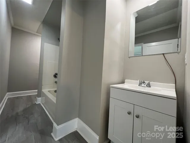 a bathroom with a sink and mirror with toilet