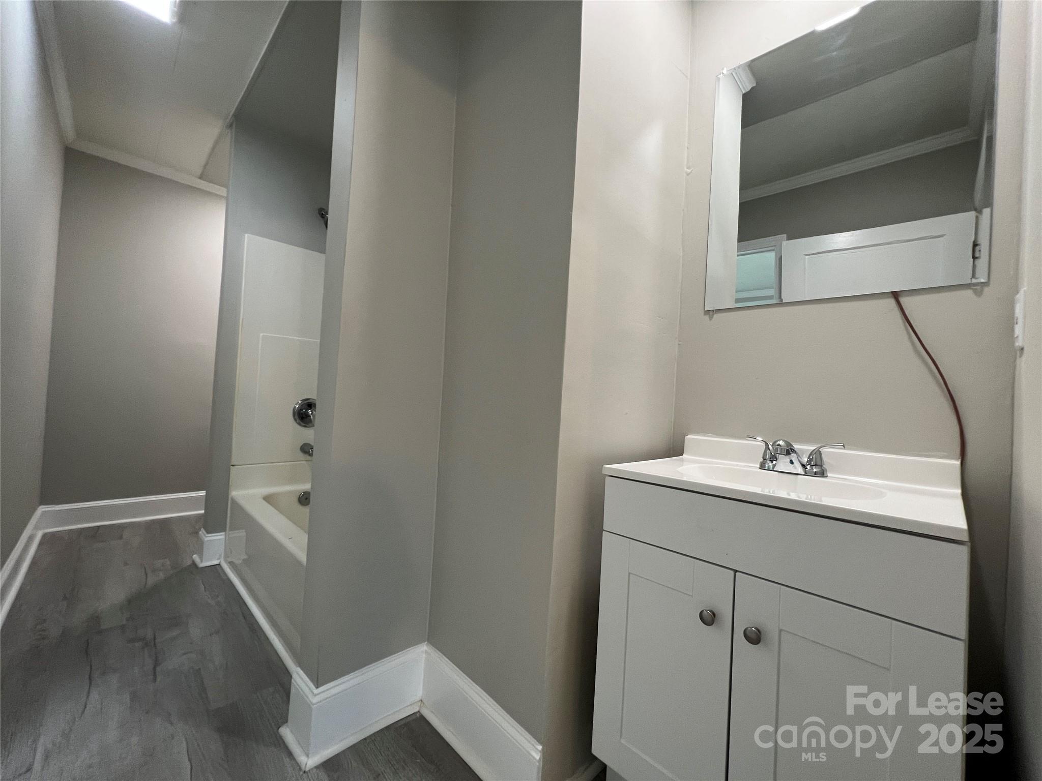 111 East Maryland Avenue Bessemer City, NC 28016 - Photo 6 of 11 a bathroom with a sink and mirror with toilet