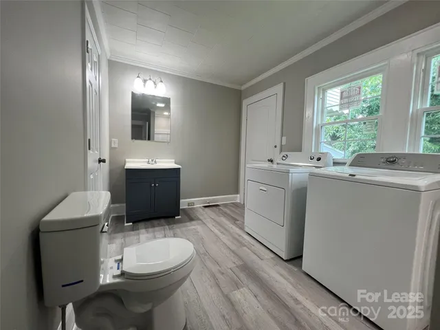a bathroom with a toilet a sink and a mirror