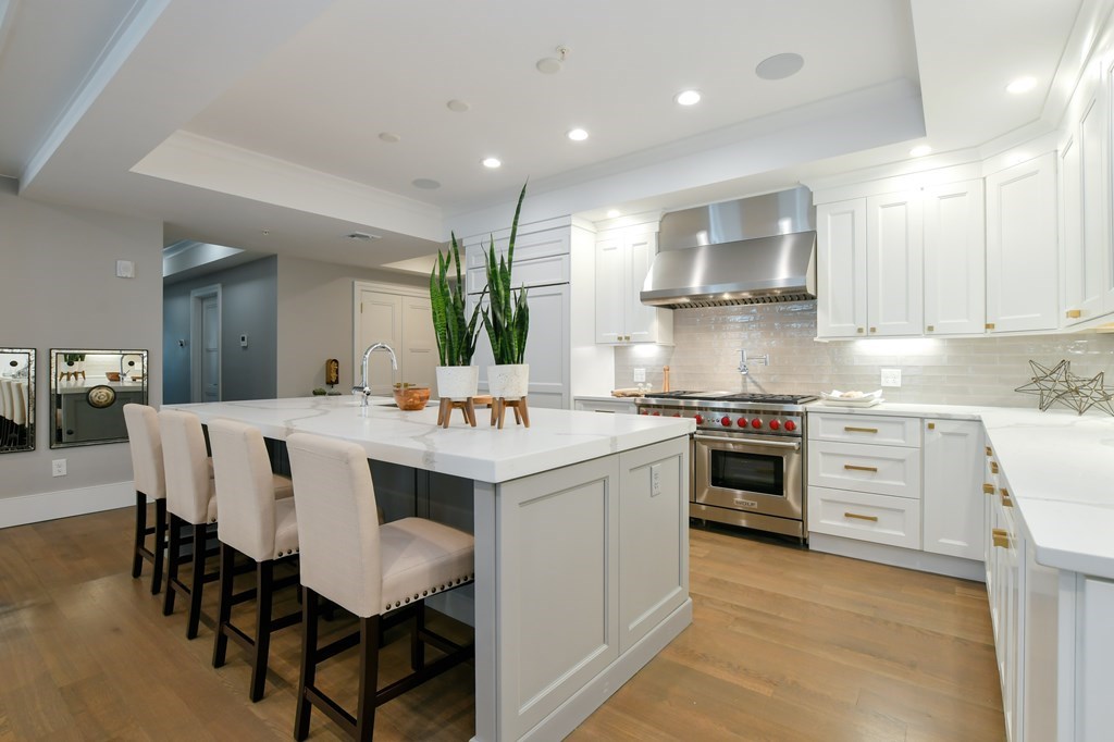 377 West First Street, Unit 2 Boston, MA 02127 - Photo 11 of 39 a kitchen with a stove a sink a dining table and chairs