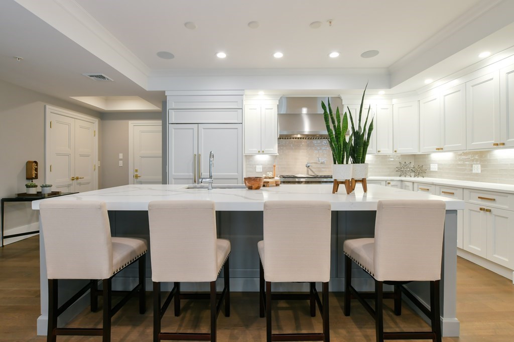 377 West First Street, Unit 2 Boston, MA 02127 - Photo 12 of 39 a kitchen with a table chairs sink and cabinets