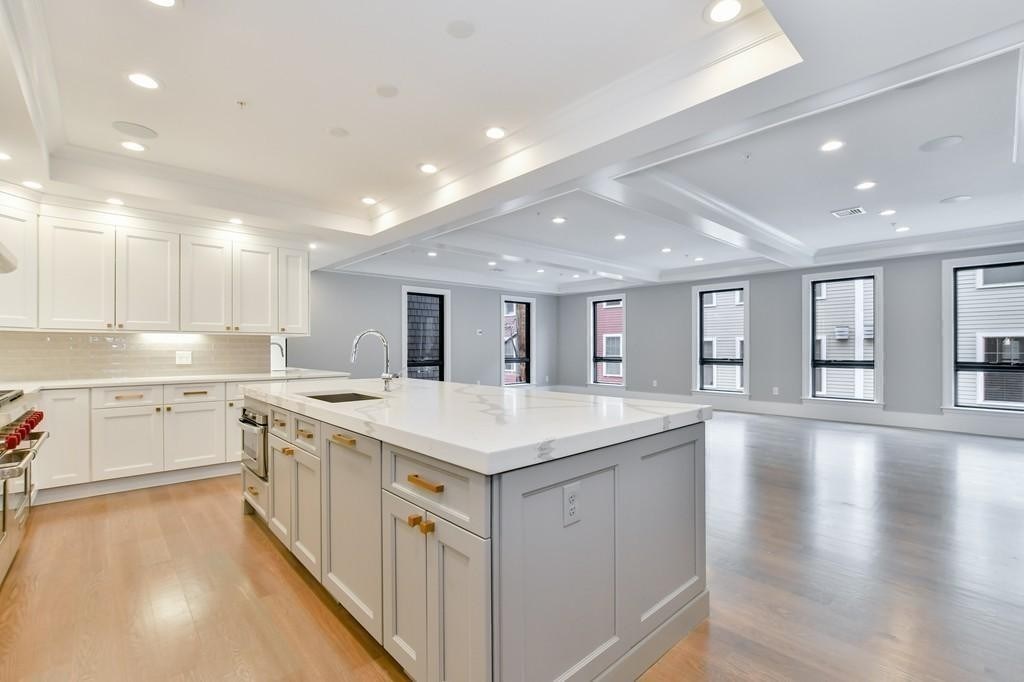 377 West First Street, Unit 2 Boston, MA 02127 - Photo 15 of 39 a kitchen with a sink stove and cabinets