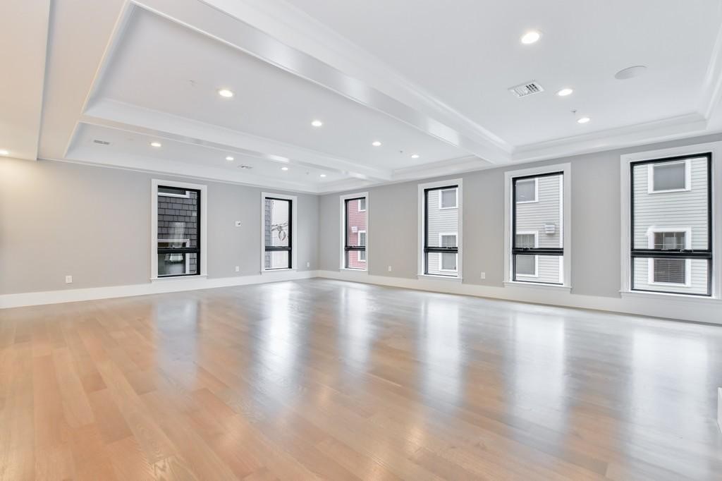 377 West First Street, Unit 2 Boston, MA 02127 - Photo 18 of 39 a view of an empty room with wooden floor and a window