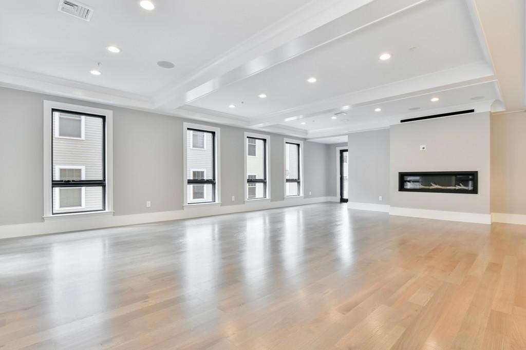 377 West First Street, Unit 2 Boston, MA 02127 - Photo 19 of 39 a view of an empty room with wooden floor and windows