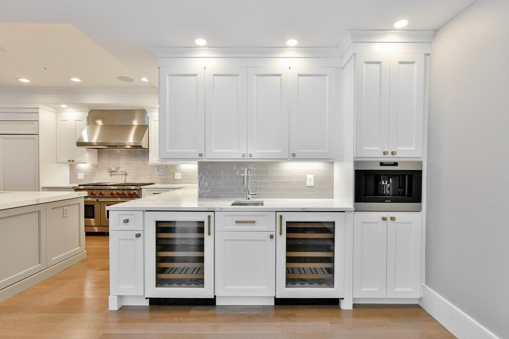 377 West First Street, Unit 2 Boston, MA 02127 - Photo 20 of 39 a kitchen with stainless steel appliances white cabinets and stove top oven