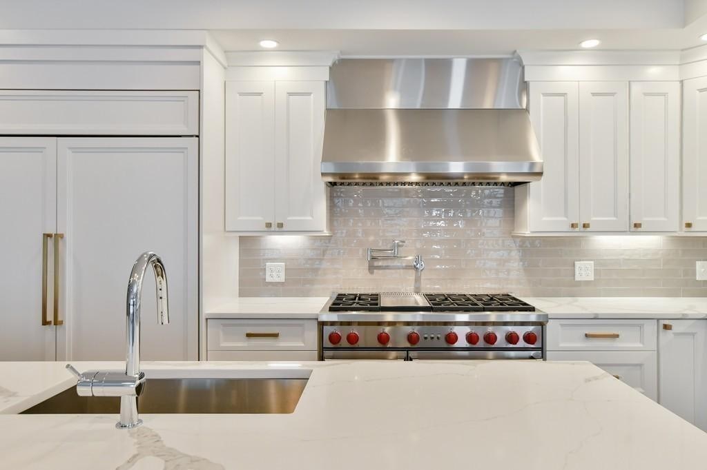 377 West First Street, Unit 2 Boston, MA 02127 - Photo 21 of 39 a kitchen with stainless steel appliances granite countertop a sink and a stove