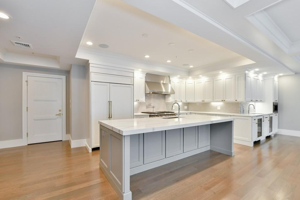 377 West First Street, Unit 2 Boston, MA 02127 - Photo 23 of 39 a large white kitchen with a sink and cabinets