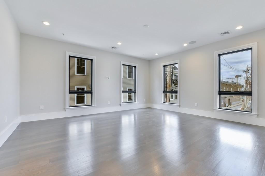 377 West First Street, Unit 2 Boston, MA 02127 - Photo 26 of 39 a view of an empty room with wooden floor and a window