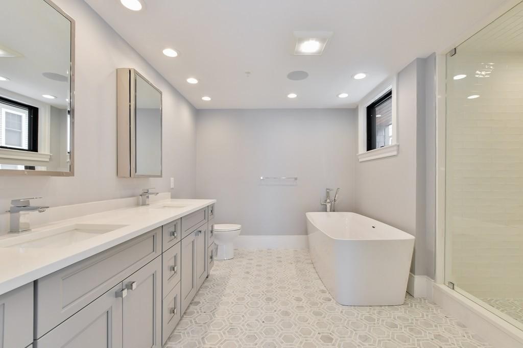 377 West First Street, Unit 2 Boston, MA 02127 - Photo 28 of 39 a bathroom with a double vanity sink mirror and bathtub