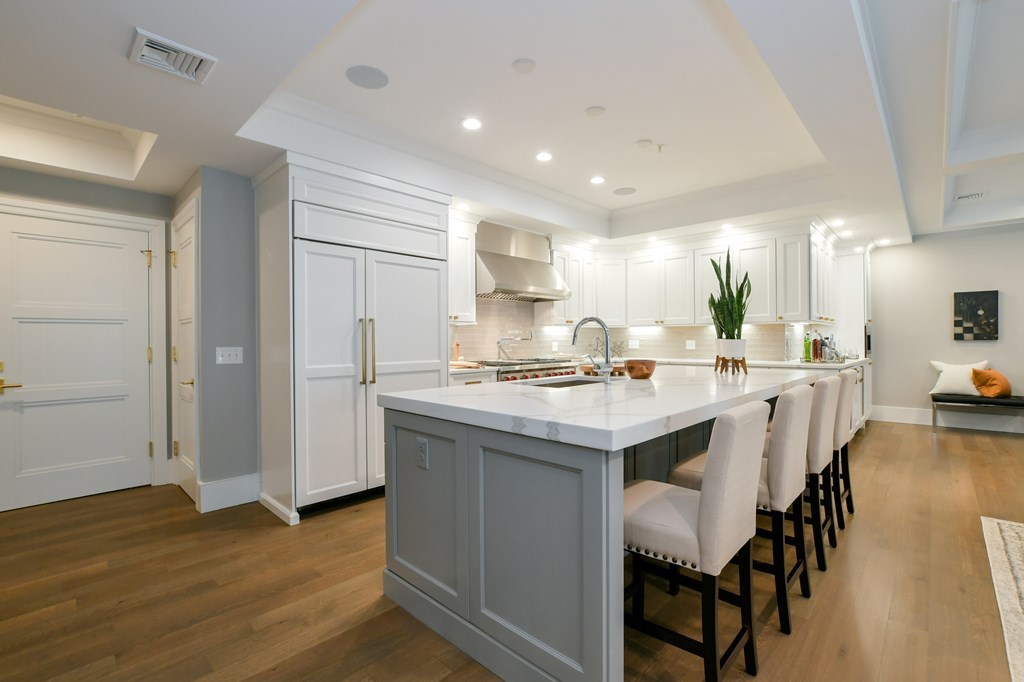 377 West First Street, Unit 2 Boston, MA 02127 - Photo 10 of 39 a kitchen with a sink and chairs