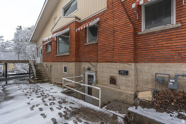 33 North 200 East Logan, UT 84321 - Photo 3 of 54 View of snowy exterior featuring brick siding